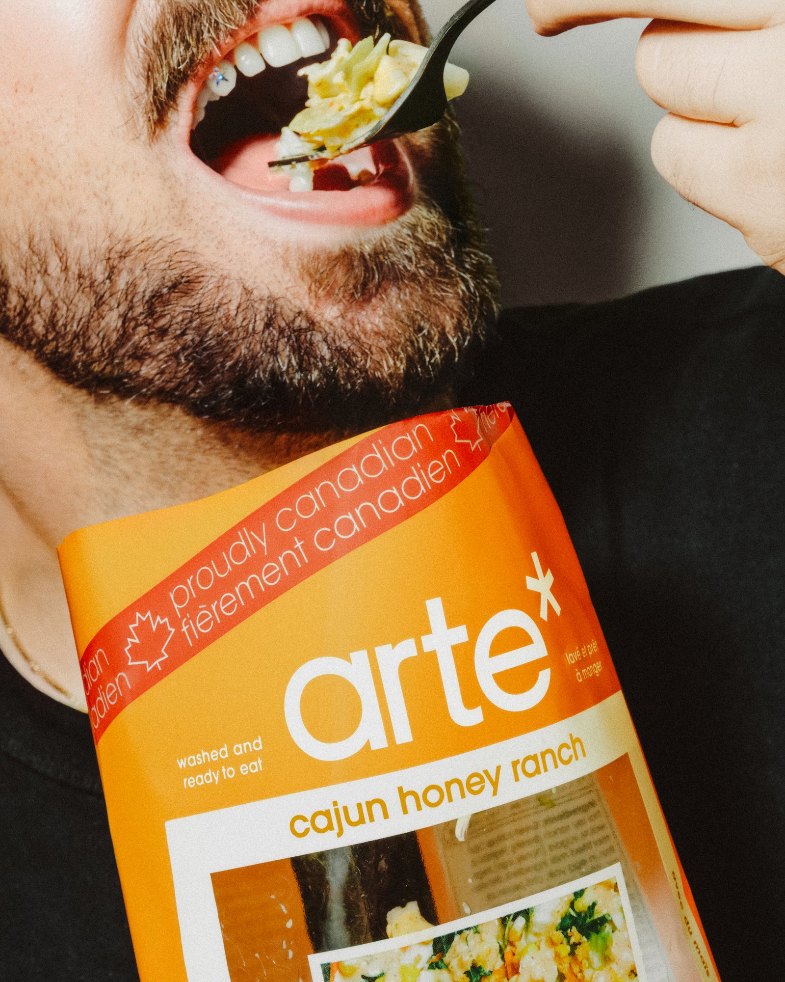 man eating arte cajun honey ranch salad