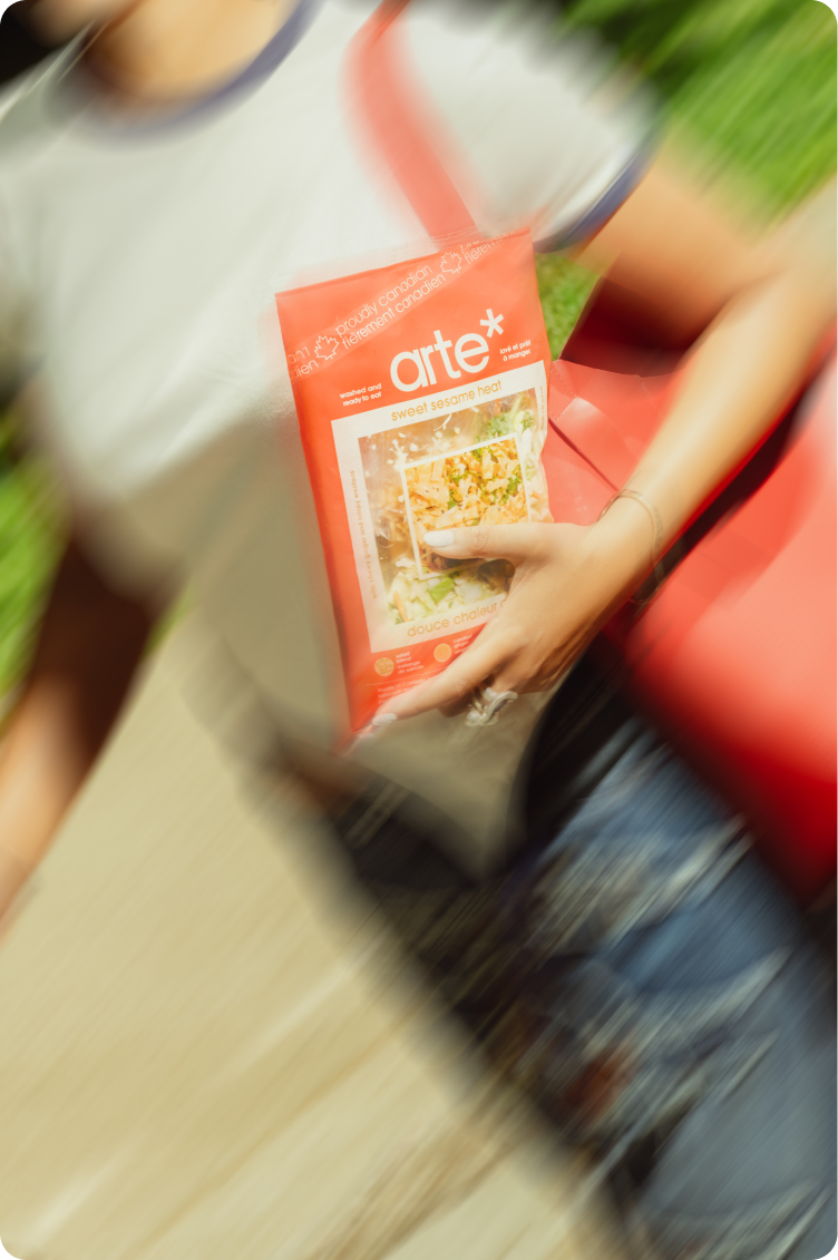 woman holding arte sweet sesame heat while running